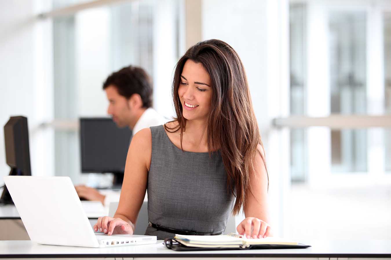 Attractive businesswoman working on laptop computer